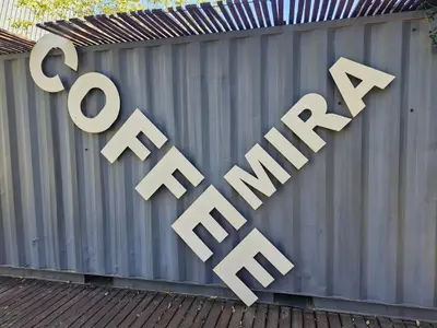 a sign that says go shopping on a fence at Emerald Studio Menlyn Maine in Pretoria