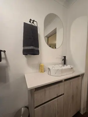 a bathroom with a sink and a mirror at Private Garden Studio near Menlyn in Pretoria