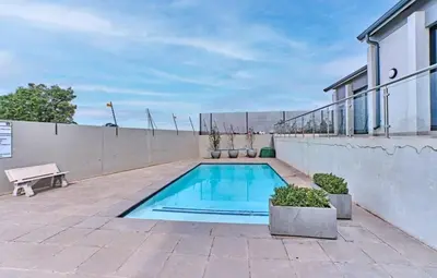 a swimming pool on the patio of a house at Unit 235 at 50 On Lever in Midrand