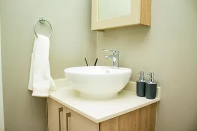 a bathroom with a white bowl sink on a counter at Unit 235 at 50 On Lever in Midrand