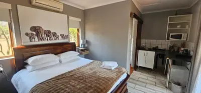 a bedroom with a large bed with white pillows at Acacia at Greenway Woods in White River