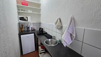 a small kitchen with a sink and a counter at Boabab at Greenway Woods in White River