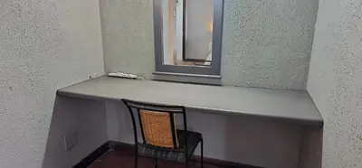 a counter with a chair sitting under a mirror at Boabab at Greenway Woods in White River