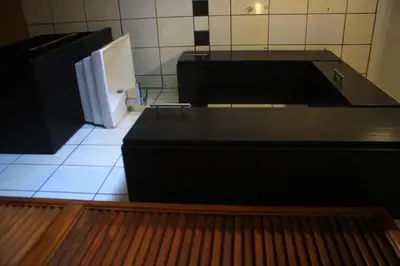 a kitchen with a black counter and a refrigerator at EvehomeStay B&B in Soshanguve