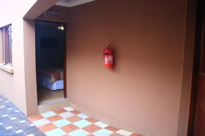 a fire extinguisher on the side of a wall at EvehomeStay B&B in Soshanguve