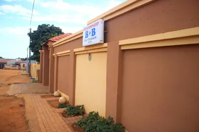 a building with a sign on the side of it at EvehomeStay B&B in Soshanguve