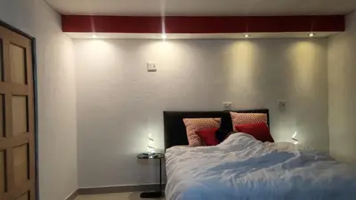a bedroom with a bed with two lamps on it at GenAyah Hotel & Safari in Mtimba