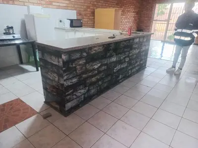 a kitchen with a stone counter in a room at I&S apartments & rentals in Burgersfort