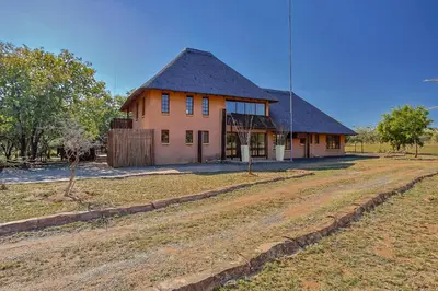 a house with a dirt road in front of it at Bush Lodge Retreat Villa 29 in Warmbaths