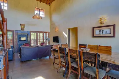 a dining room with a table and chairs at Bush Lodge Retreat Villa 29 in Warmbaths