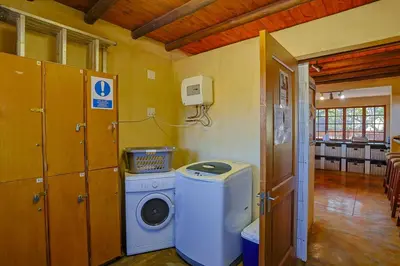 a laundry room with a washing machine in a room at Bush Lodge Retreat Villa 29 in Warmbaths