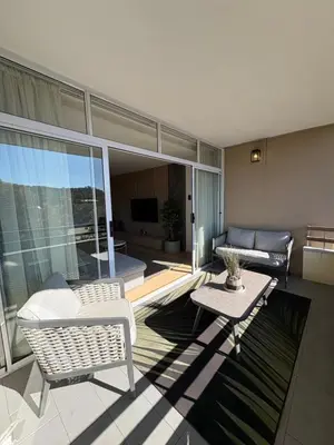 a living room with a couch and a table at Nare Penthouse in Pretoria