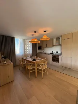 a kitchen with a table and chairs in a room at Nare Penthouse in Pretoria