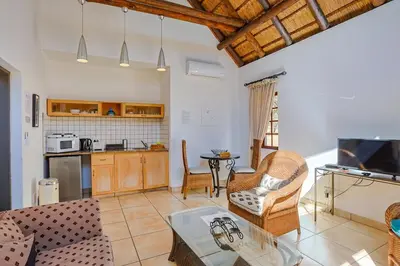 a living room with a couch and a table at Stunning Bushveld Villa 84 in Warmbaths
