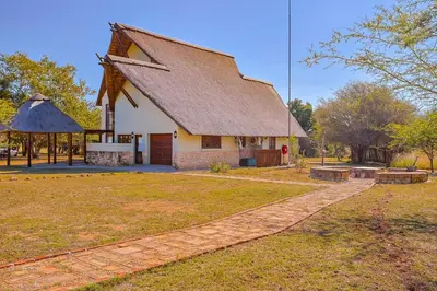 a large church with a stone path in front of it at Stunning Bushveld Villa 84 in Warmbaths