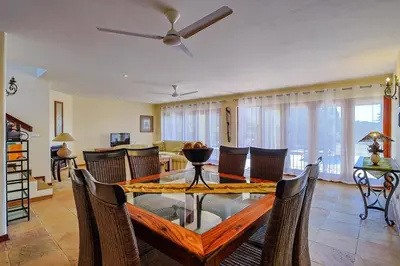 a living room with a dining table and chairs at Stunning Bushveld Villa 84 in Warmbaths