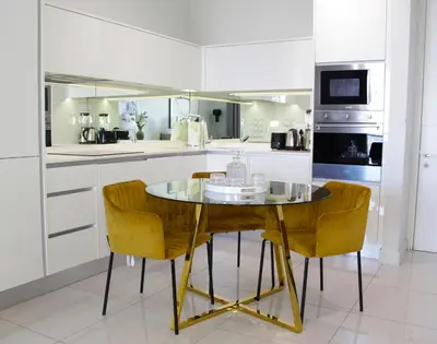 a kitchen with a glass table and chairs at 1Bed Stylish Apartment - Waterfall in Midrand