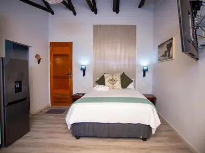a bedroom with a large bed in a room at Golden Casa in Mokopane