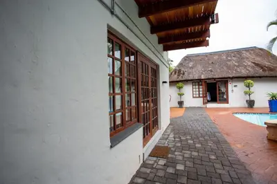 a courtyard of a house with a pool and a building at Golden Casa in Mokopane