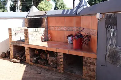 a brick wall with a fire place on it at Golden Casa in Mokopane