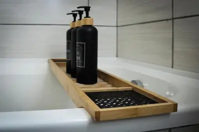 a couple of bottles sitting on a bath tub at The Grey Oasis in Tzaneen