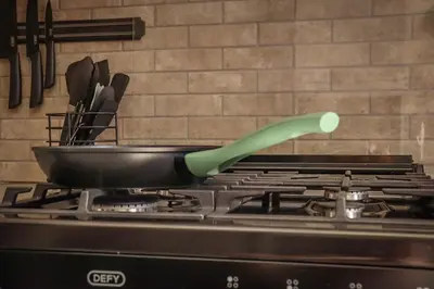 a pan on top of a stove with a spatula at The Grey Oasis in Tzaneen