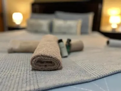 a towel sitting on top of a bed at Nkandla Yethu Guest House in Nelspruit