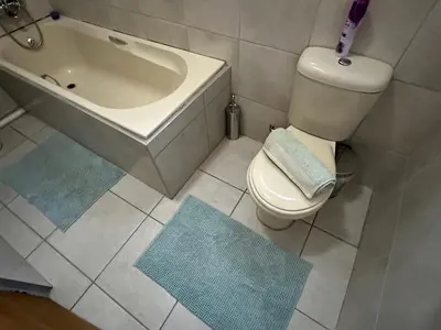 a bathroom with a tub and a toilet and a sink at Nkandla Yethu Guest House in Nelspruit