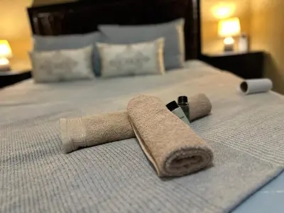 a pair of towels on top of a bed at Nkandla Yethu Guest House in Nelspruit