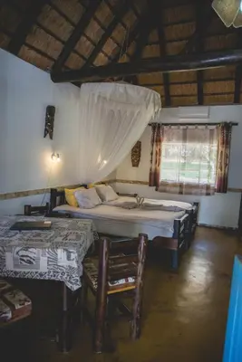 a bedroom with two beds and a window at Thokozani Lodge in White River