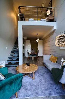 a living room with a couch and a table at Luxurious Loft in Pretoria