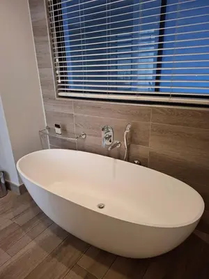 a white bath tub in a bathroom with a window at Luxurious Loft in Pretoria