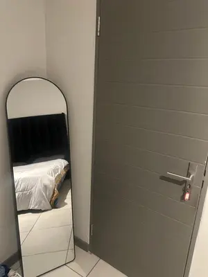 a door with a mirror next to a bedroom at The Parks in Midrand