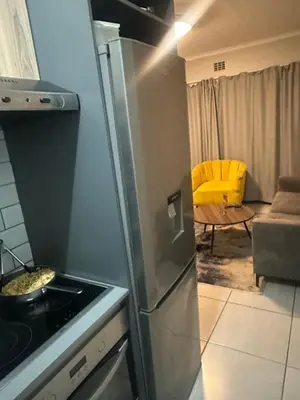 a kitchen with a stainless steel refrigerator and a stove at The Parks in Midrand