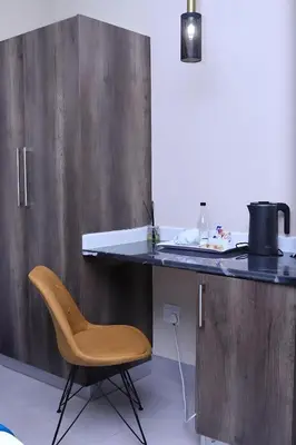 a kitchen with a chair next to a counter at Masana Hotels in Polokwane