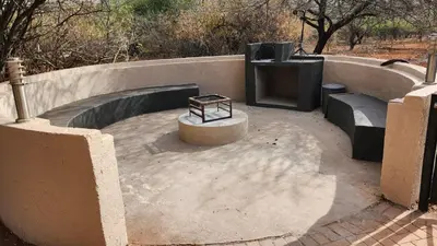 a bench sitting on top of a concrete patio at Lion's Pride - Marloth Park in Marloth Park