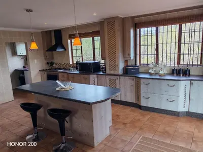 a large kitchen with a large island in the middle at Lion's Pride - Marloth Park in Marloth Park
