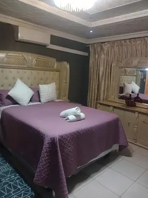 a bedroom with a purple bed and a mirror at Newview bnb and spa in Thulamahashi