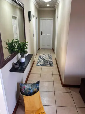 a hallway with a door and a tile floor at Guesthouse at 543 in Lebowakgomo