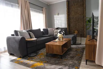a living room with a couch and a coffee table at Basambilu Guesthouse in Kempton Park
