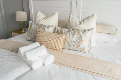 a group of pillows sitting on a bed at Basambilu Guesthouse in Kempton Park
