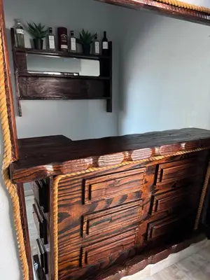 a wooden dresser with a mirror on a wall at Basambilu Guesthouse in Kempton Park