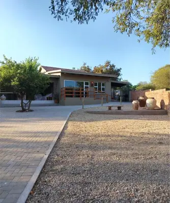 a building with a pathway in front of it at Ukulala Inn in Malelane
