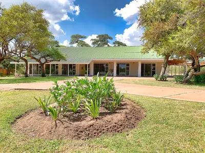 a building with a plant in front of it at Tshikwalo Game Lodge in Klipdrift