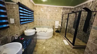 a bathroom with a tub and a sink and a bath tub at Sejpro Living at 1 Motse Street in Polokwane
