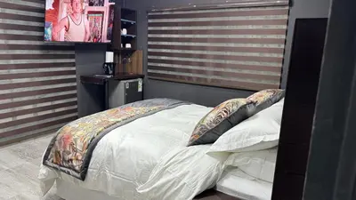 a bedroom with a bed with a headboard and a television at Sejpro Living at 1 Motse Street in Polokwane