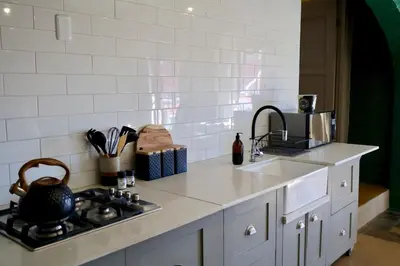 a kitchen counter with a sink and a stove at Cherry Nest in Dullstroom