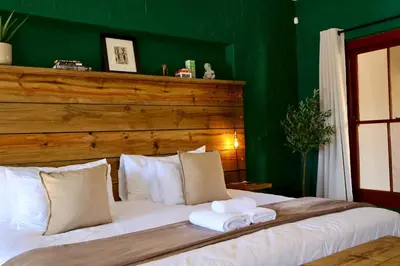 a bedroom with a bed with two towels on it at Cherry Nest in Dullstroom
