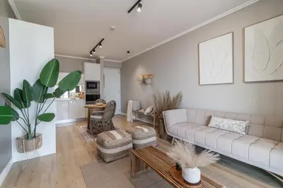 a living room with a couch and a table at Hospitality at Waterfall City - Ellipse Waterfall in Midrand
