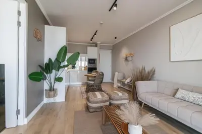 a living room with a couch and a table at Hospitality at Waterfall City - Ellipse Waterfall in Midrand